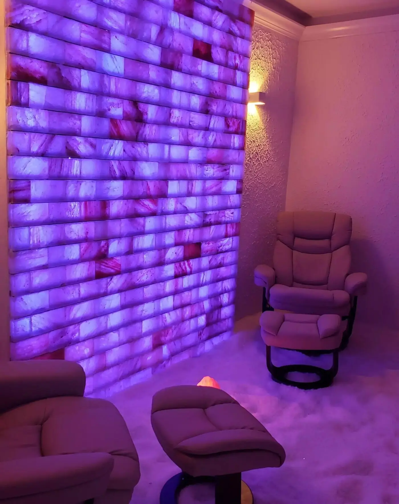 The salt wall lit violet, with zero gravity recliners in the foreground